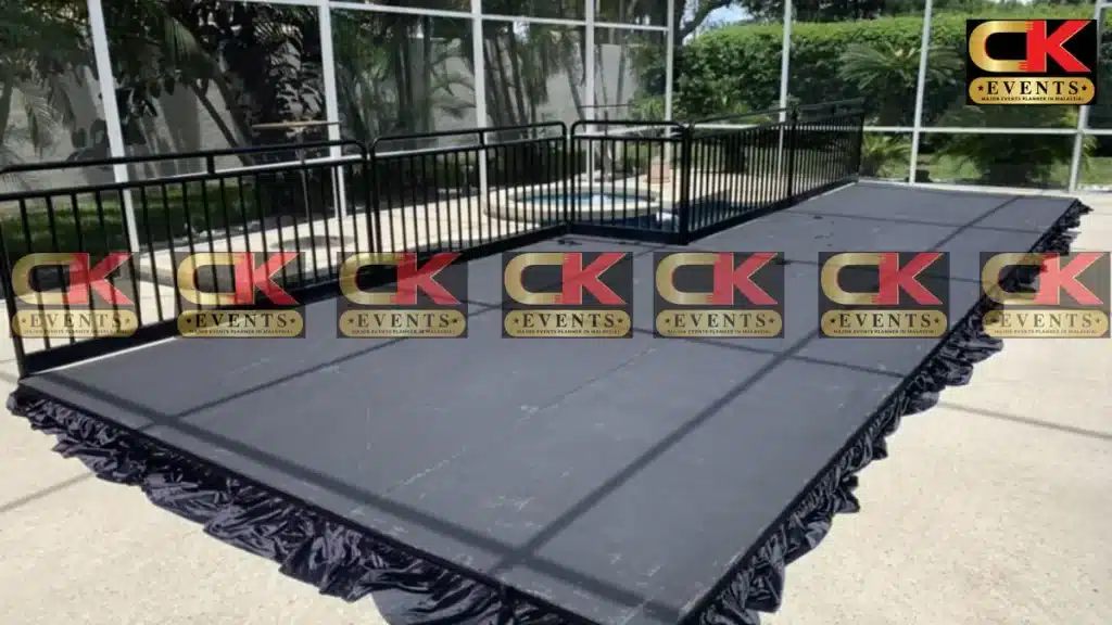 Portable black modular outdoor stage set up for event rental
