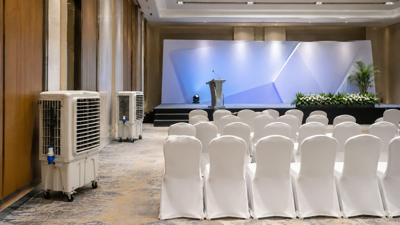 Air cooler rental Kuala Lumpur hotel dewan event setup with stage and guest chairs