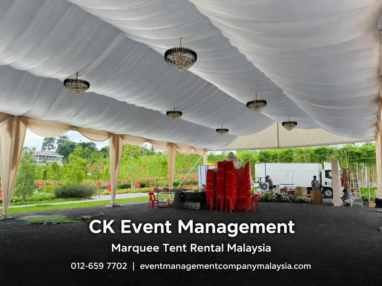 Wide draped marquee interior with chandeliers and open event space