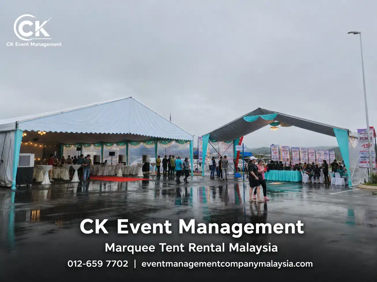 Rainy outdoor event canopy setup with wet floor reflections and guest areas