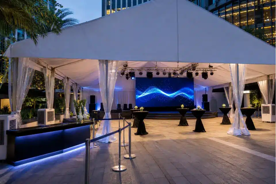 Corporate launch marquee sample in Malaysia with stage, LED backdrop, lighting, speakers and cocktail tables