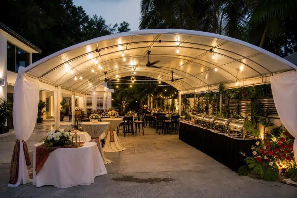 Half moon party canopy sample in Malaysia with curved roof, buffet zone, bar tables and warm lights