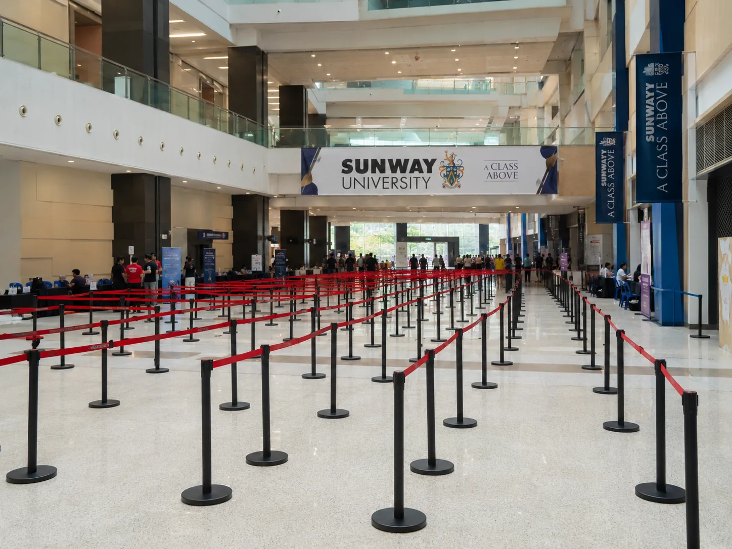Black Q pole with red 2 meter belt large deployment at Sunway University event registration atrium