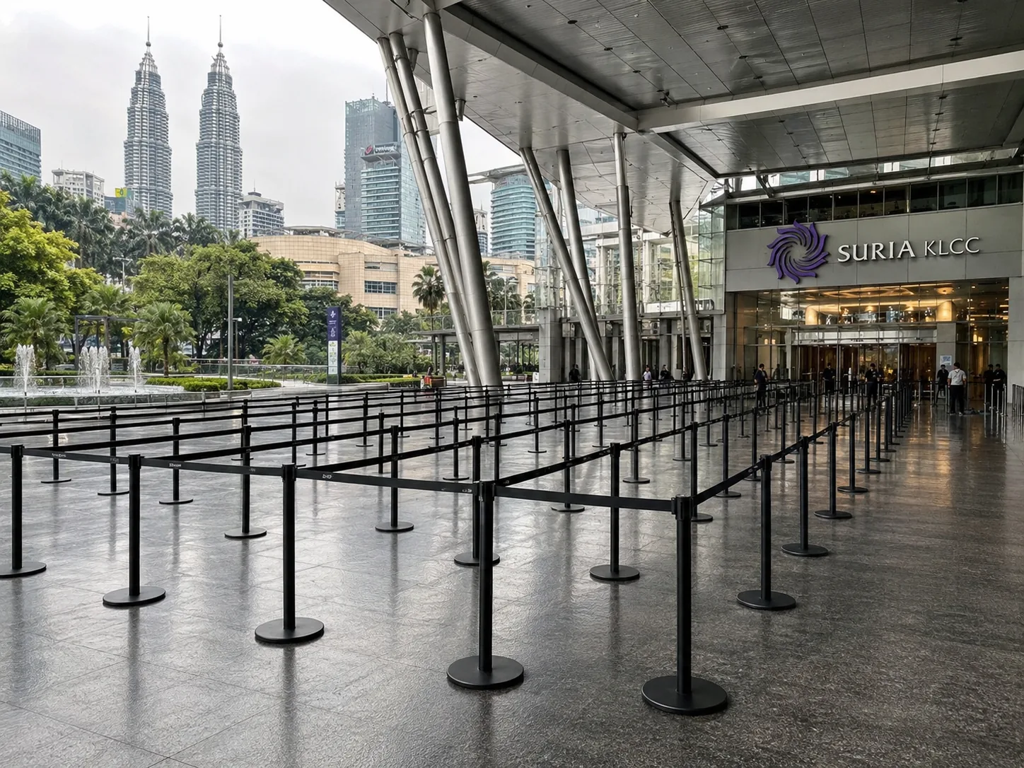 Large black Q pole with black belt queue deployment outside Suria KLCC with Petronas Twin Towers view