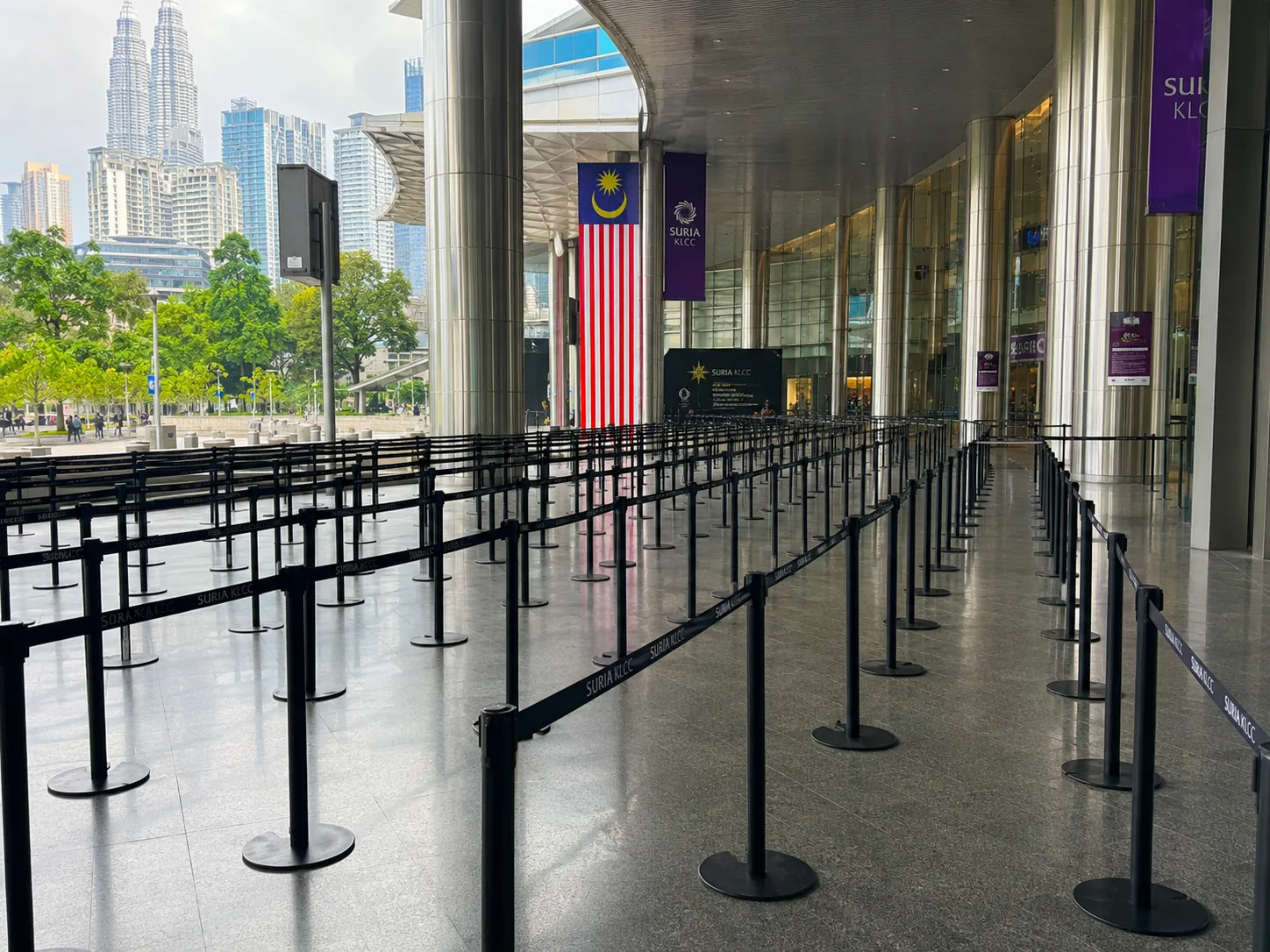 Black Q pole and black belt queue management setup at Suria KLCC mall entrance in Kuala Lumpur